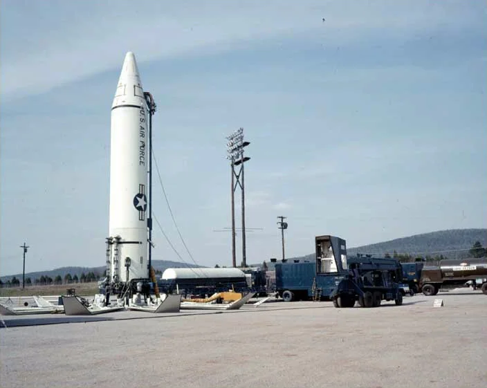 A Jupiter ballistic missile standing vertically on its launch pad.