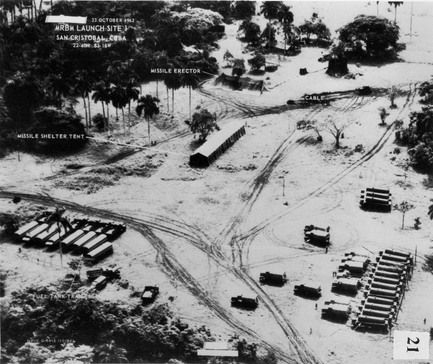 Low-level reconnaissance photograph dated 23 October 1962 of San Cristóbal Site 1, with original labels identifying the covered missile erector, shelter tent, cable and fuel tank trailers.
